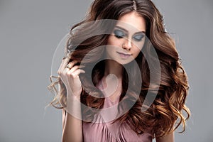 Closeup beauty portrait of young woman with natural makeup and hairstyle