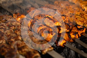 Closeup of beef kebabs, sheesh taweq and chicken kebabs on charcoal