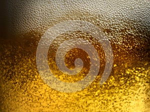 Closeup beer pour with frothy head and bubbles photo