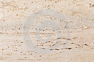 Closeup of beige porous stone textured wall