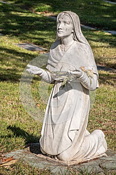 Closeup of Bernadette of Lourdes statue, Calvary Cemetery. Santa Barbara, CA, USA