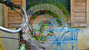 Closeup Bicycle Rudder with Basket full of flowers and Blur Background