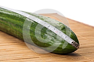 Closeup with a big cucumber and a centimeter