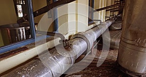 Closeup of big pipes and valves connected to the boilers