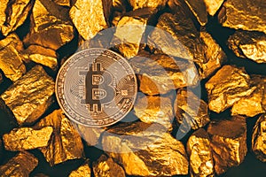 Closeup of bitcoin digital currency and gold nugget or gold ore