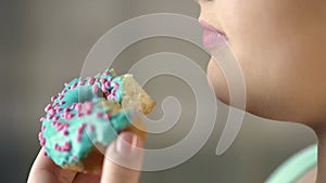 Closeup of bitten donut, chubby woman eating unhealthy food, diabetes, obesity
