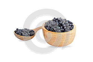 Closeup black beans seeds in wooden bowl on white background, healthy food concept