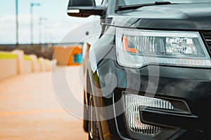 Closeup of black car headlights