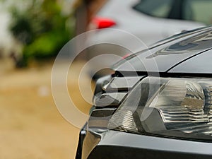 Closeup of a black car headlights detail