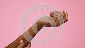 Closeup Of Black Female's Hands Scratching Itchy Skin, Pink Background