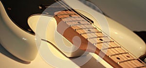 Closeup.black guitar on a white background.