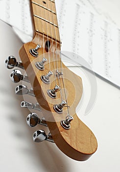 Closeup.black guitar on a white background.