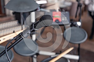 Closeup black iron microphone and cymbals on stage restaurant hall served for banquet. Concept live music concert bar in evening,