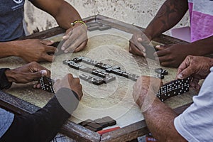 Closeup of black Latinos hands playing dominoes in the neighborhood of La Marina Matanzas, Cuba