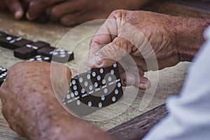 Closeup of black Latinos hands playing dominoes in the neighborhood of La Marina Matanzas, Cuba