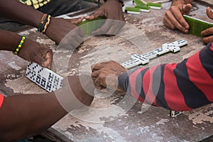 Closeup of black Latinos hands playing dominoes in the neighborhood of La Marina Matanzas, Cuba