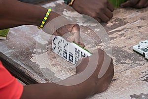 Closeup of black Latinos hands playing dominoes in the neighborhood of La Marina Matanzas, Cuba