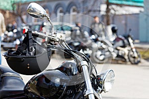 Closeup black moto helmet on motorcycle handlebars