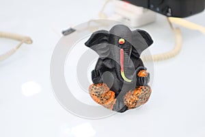 Closeup of a black statue of an elefant on a white background