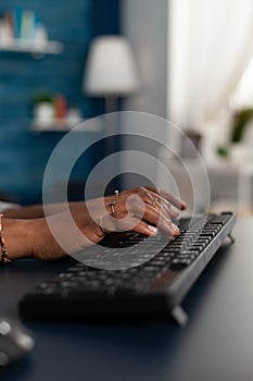Closeup of black student hands typing education information on keyboard