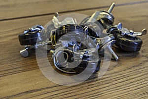 Closeup of black wheels for carts on a wooden table under the lights