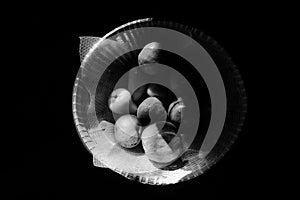closeup black and white fruits in a basket with sunlight