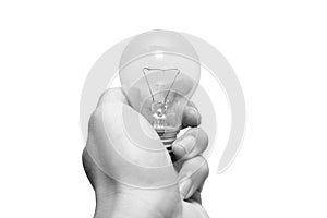 Closeup black and white man hand holding old tungsten light bulb isolated on white background