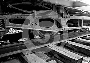 Closeup black and white image of old vintage tram wheels on rails