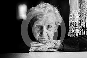 Closeup black and white portrait of an elderly woman.