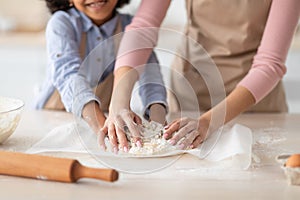 Closeup of black woman and daughter kneading dough