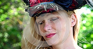 Closeup blond woman with historic costume with hat blue eyes blond hair