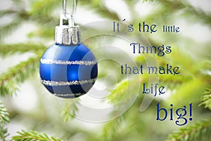 Closeup Of A Blue Christmas Ball With Life Quote
