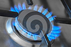 Closeup of the blue flames from a gas stove in a kitchen