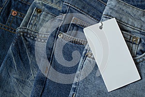 Closeup of blue jeans with white blank for price tag or your text