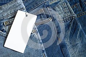 Closeup of blue jeans with white blank for price tag or your text.