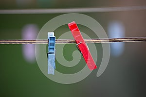 Closeup of blue and red clothes pins on string