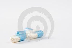 Closeup blue-white antibiotics capsule pills. Pharmacy background. Antimicrobial drug resistance. Pharmaceutical industry. Global