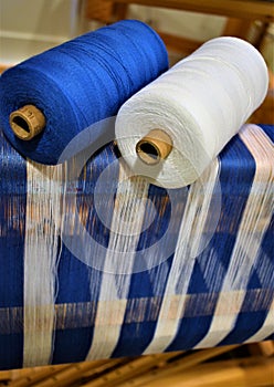 Closeup of Blue and white striped warp with two cotton yarns used in warp. Weaving. Handweaving. Textiles. Fiber.