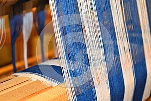 Closeup of Blue and white striped warp. Weaving. Handweaving. Textiles. Fiber.