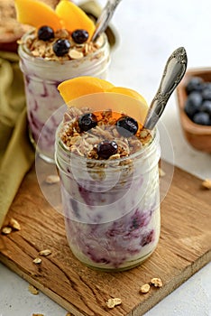 Closeup of blueberry and peach granola parfait