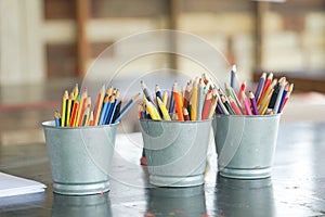 Closeup blunted color pencils in metal buckets