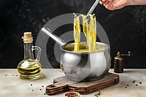 Closeup of boiling spaghetti pasta. put salt and olive oil inside water in the pot