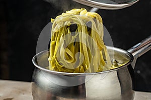 Closeup of boiling spaghetti pasta. put salt and olive oil inside water in the pot