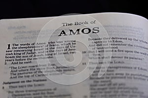 Closeup of the Book of Amos from Bible or Torah, with focus on the Title of Christian and Jewish religious text.