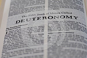 Closeup of the Book of Deuteronomy from Bible or Torah, with focus on the Title of Christian and Jewish religious text.