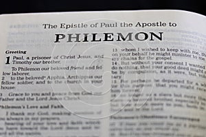 Closeup of the Book of Philemon from Bible, with focus on the Title of religious text.