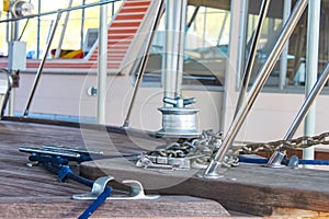 Closeup of bow on old wooden boat with anchor chain and mooring rope with other boats blurred behind