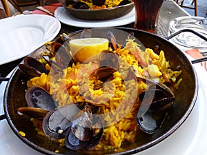 Closeup of a bowl of rice with mussels and shrimps on the table