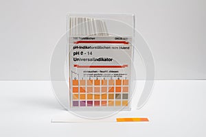 Closeup of a box of pH indicator test strips on a white background.