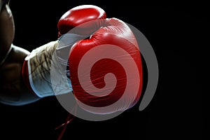 closeup of boxers clenched fist with red glove